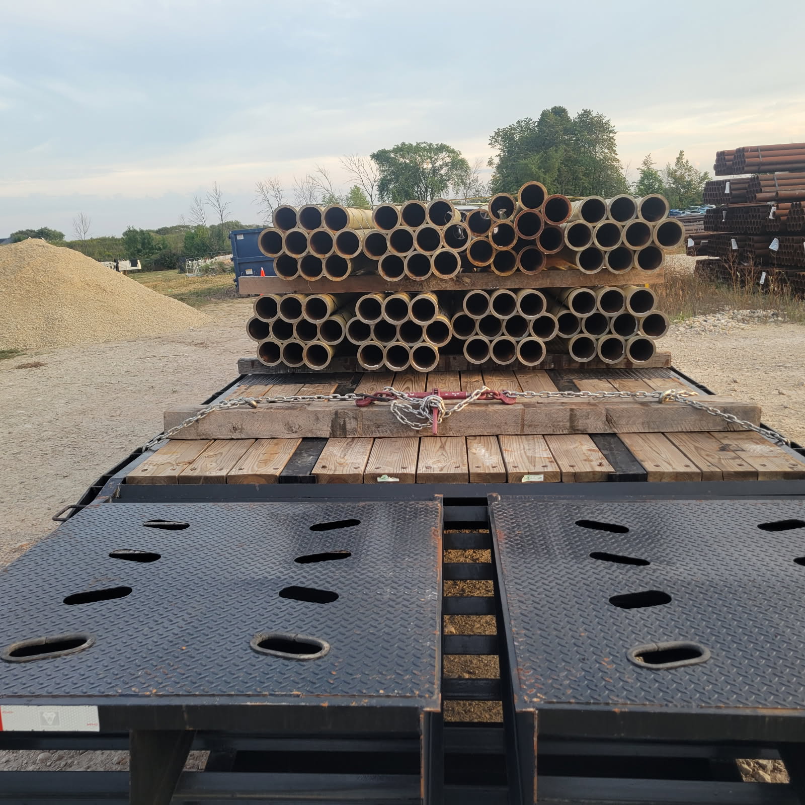Chained Steel Pipe Bundles on Ramped Flatbed
